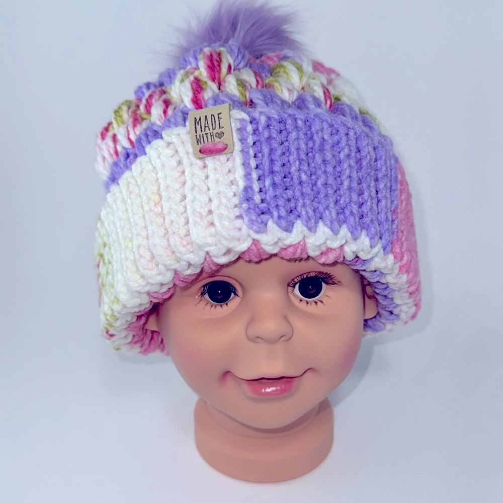 #17 This is a beautiful crocheted winter hat with a purple pom-pom on top.